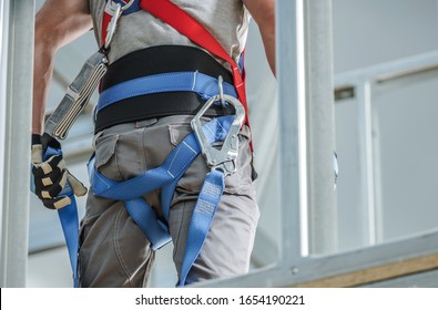 Construction Safety Equipment. Industrial Worker Wearing Safety Harness. Closeup Photo.