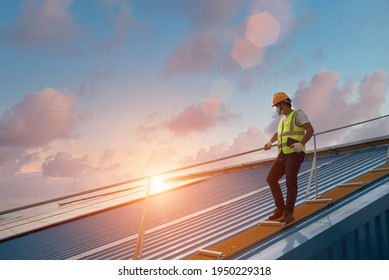 Construction safety inspection engineer installs new corrugated roof engineer working on checking equipment in solar power plant