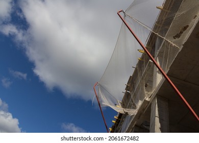 Construction safety net. A construction mesh that prevents objects from falling from a building under construction. Construction mesh is installed on the upper floors of the building