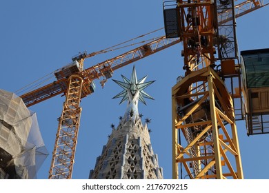 Construction of Sagrada Família, Spain. The tower devoted to Virgin Mary, with a star on top, is surrounded by cranes.