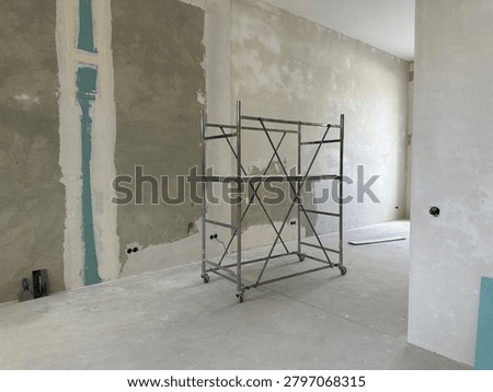 Construction scaffold in empty room during building renovation