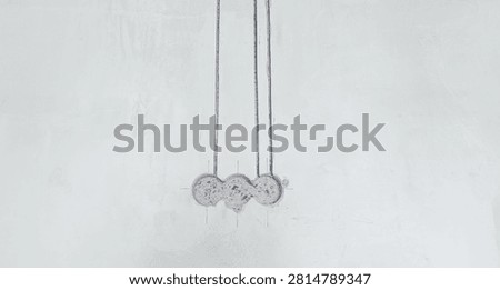 Construction scene: three vertical channels drilled into a concrete wall for wiring, with back boxes prepared for outlets.