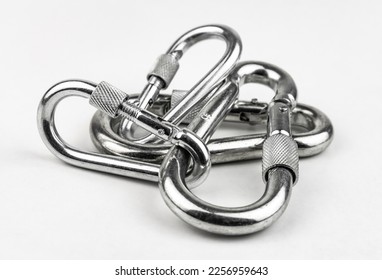 Construction screw-lock carabiner from stainless steel isolated on white background. Compact screw carabiner