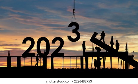 Construction sets numbers for New Year 2023,Silhouette of team works as a to prepare to welcome the new year 2023.  - Shutterstock ID 2226482753