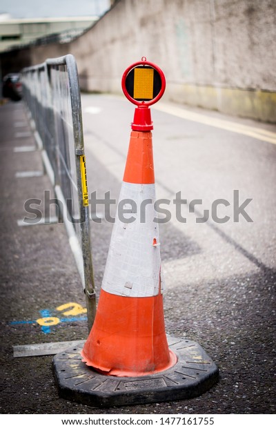 Construction\
side road signal and fence in an urban\
setup