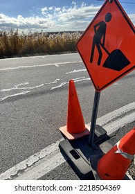 Construction Signalisation On The Side Of The Road For Asphalt Crack Filling Jon With Two Orange Construction Cones