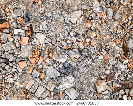 Construction site, background, texture, design. Construction waste from broken white and orange bricks. Urbanistic, environmental pollution.