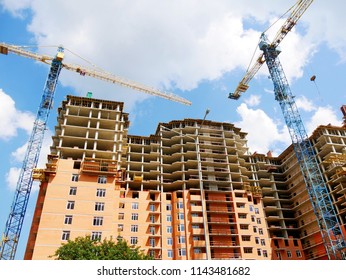 Construction site background. Two cranes near building. Construction site with crane and building.