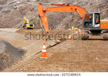 Construction site: Backhoe making banked slope