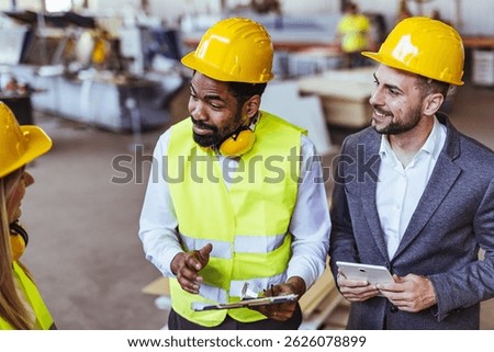 Construction site collaboration with engineers and manager discussing project plans and logistics.