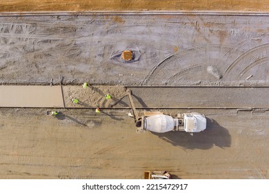 At Construction Site Concrete Mix Truck Is Workers Pouring Cement During Construction Of Sidewalk