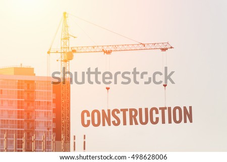 Construction site with crane at sunset
