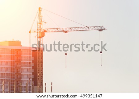 Construction site with crane at sunset