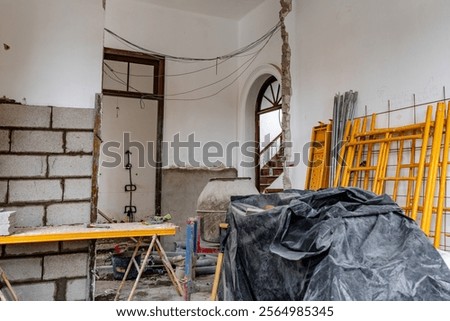 A construction site with a lot of debris and tools. Scene is chaotic and disorganized