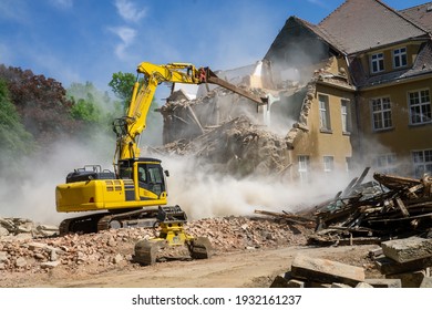 Construction site digger yellow demolishing house for reconstruction