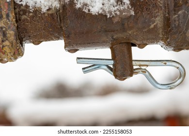 Construction site . An element securing the pin against falling out. Stainless cotter pin with water drops from melting snow. Securing the connection of steel structure elements. 