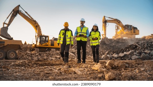 Construction Site With Excavators on Sunny Day: Diverse Team Of Male And Female Specialists Walking And Discussing Real Estate Project. Engineer, Architect, Urban Planner Talking, Using Tablet.