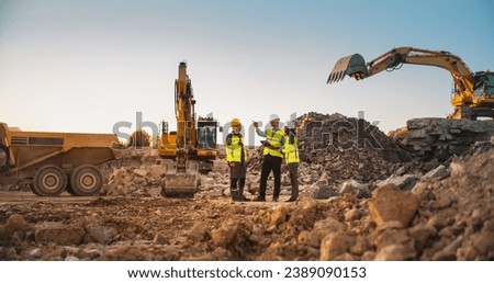 Construction Site With Excavators on Sunny Day: Diverse Team Of Male And Female Real Estate Developers Discussing Project. Engineer, Architect, Investor Talking About Apartment Building, Using Tablet