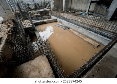 A construction site featuring a large puddle of standing water