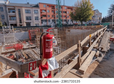 Construction site. Fire extinguishing point.Red powder fire extinguisher with operating instructions 