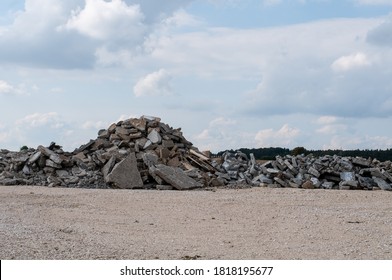 A Construction Site With Gravel Floor And A Pile Of Broken Rubble