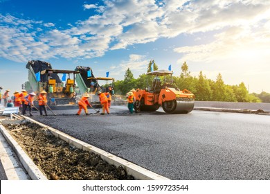 Construction site is laying new asphalt road pavement road construction workers   road construction machinery scene 