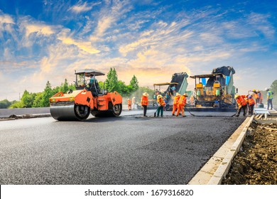 Construction site is laying new asphalt road pavement,road construction workers and road construction machinery scene.highway construction site landscape.