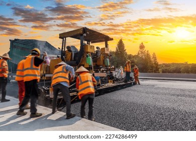 Construction site is laying new asphalt pavement  road construction workers   road construction machinery scene  Highway construction site scene 