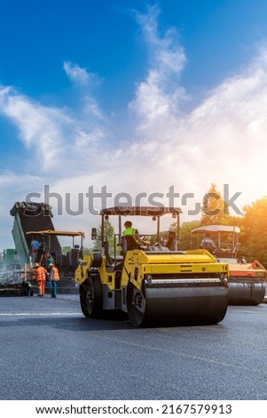 Construction site is laying new asphalt pavement. road construction workers and road construction machinery scene. Highway construction site scene in China.