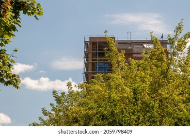 Construction site of modern residential buildings amog trees