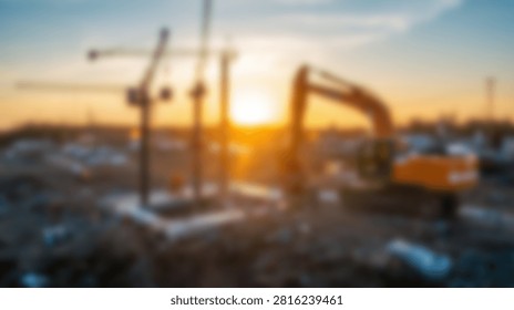 A construction site with multiple cranes and an excavator is silhouetted against a vibrant sunset sky.