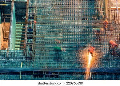 Construction Site At Night With Workers Who Weld