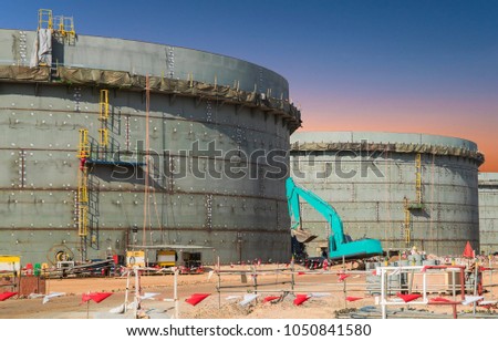 Construction site of oil and gas industrial, Huge oil storage tank ,Heavy construction machine doing building  with the workers 