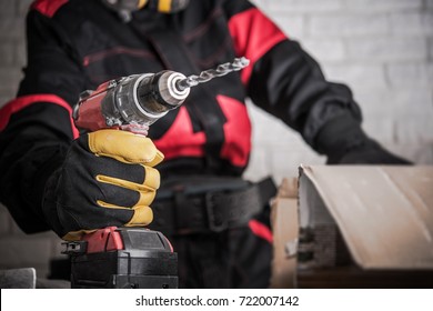 Construction Site Power Drill Tools. Contractor Worker With Powerful Cordless Drill Driver In Hand. Drilling Makes Easy Concept.