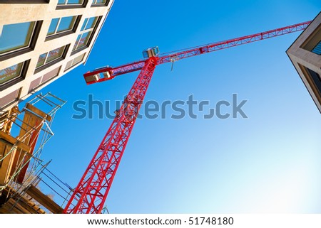 Construction site with a red crane.