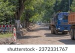 Construction site (renovation) of a city street (road).Road renovation - the stage of removing the old surface and substructure. Excavator trucks and other construction machines visible.