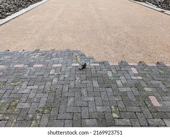 Construction Site And Renovation Concept Paving: Top View Of A Construction Site With A Half-paved Plot Of Land And A Rubber Mallet In The Foreground - Lots Of Copy Space