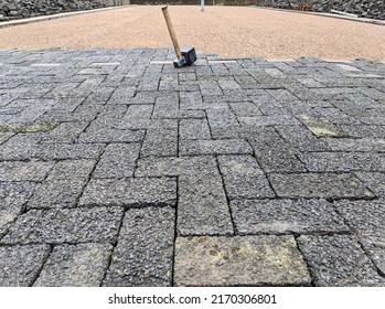 Construction Site And Renovation Concept Paving: Top View Of A Construction Site With A Half-paved Plot Of Land And A Rubber Mallet In The Foreground - Lots Of Copy Space