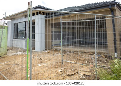 The Construction Site Of A Residential Suburban House With A Temporary Fence. Concept Of Real Estate Development, Houses For Sale, And The Housing Market. Melbourne, VIC Australia.