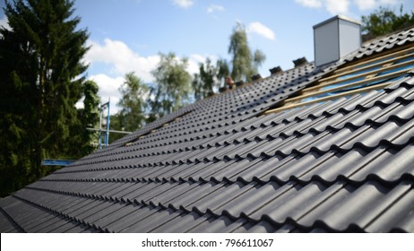construction site roofing black tiles - Shutterstock ID 796611067