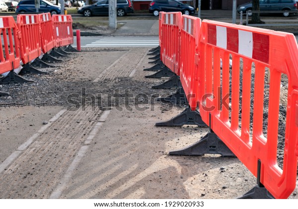 Construction site and safety barriers. Road\
repair and safety. Trafic lights and\
crosswalk.