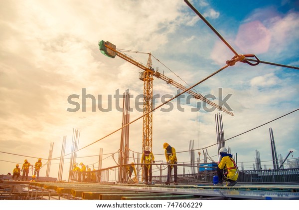 construction site and\
sunset , structural steel beam build large residential buildings at\
construction site\
.