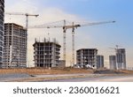 Construction site with tower crane. House and buildings construction. Hotel apartments construction. Housing renovation, real estate. Crane on formwork in Built environment. Cranes on pouring concrete