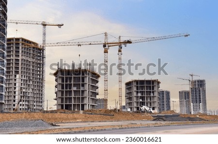 Construction site with tower crane. House and buildings construction. Hotel apartments construction. Housing renovation, real estate. Crane on formwork in Built environment. Cranes on pouring concrete