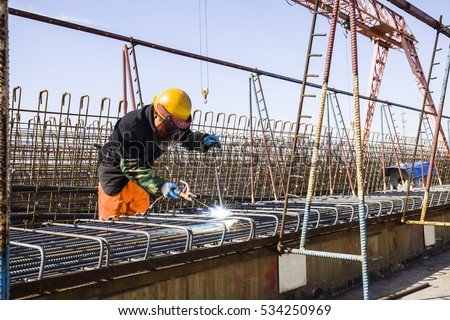 In the construction site, the welding workers at work