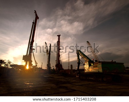 Construction site whit machine or cran at dusk evening sunset background