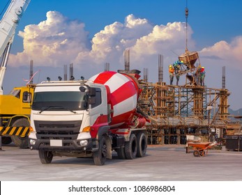 Construction site worker during concrete pouring into formwork at building area with skip; Concreting work - Shutterstock ID 1086986804