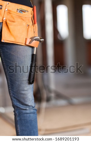 construction site worker wearing velt with tools