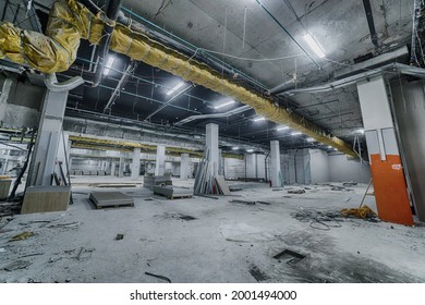 Construction of spacious well-lit underground car park with parking spaces. Empty parking garage underground, industrial interior. Construction works