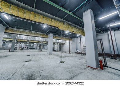 Construction of spacious well-lit underground car park with parking spaces. Empty parking garage underground, industrial interior